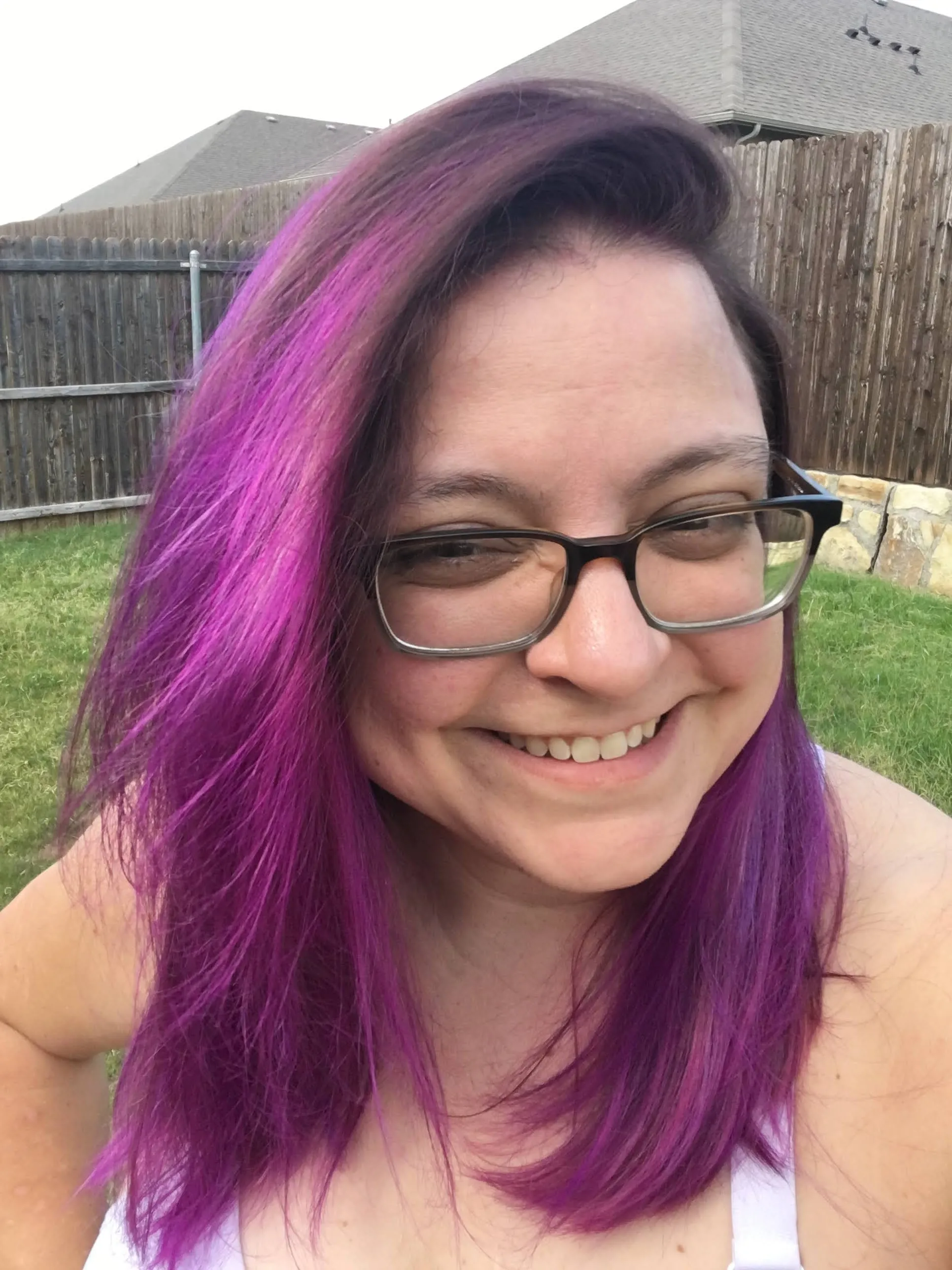 A close up of Linda showing off her freshly dyed brown and violet purple hair.