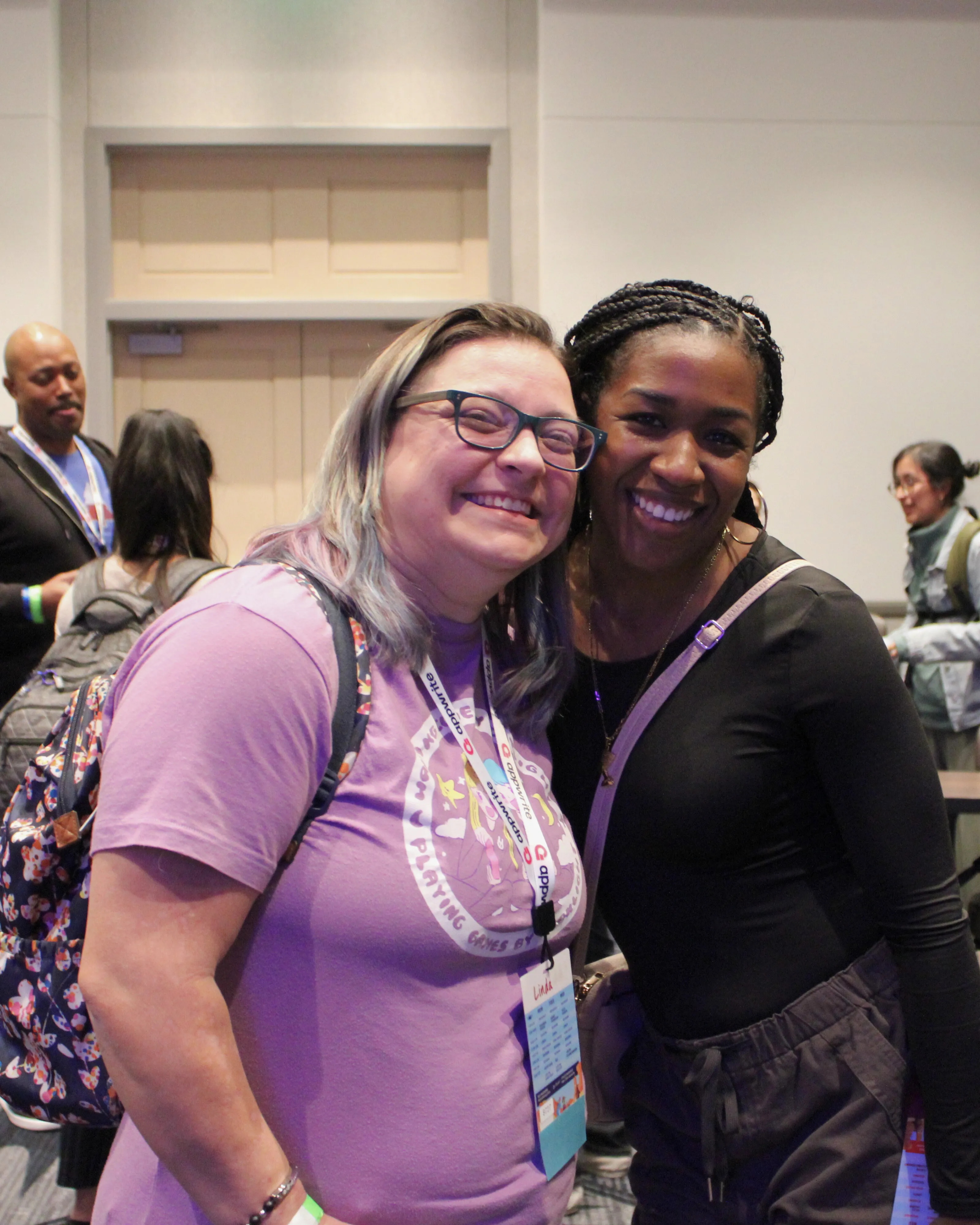 Linda and Shaundai stand next to each other, grinning at the camera.